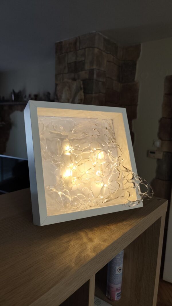 Lumina 3D resin sculpture by Mirjana Fat in a minimalist white frame with integrated light.